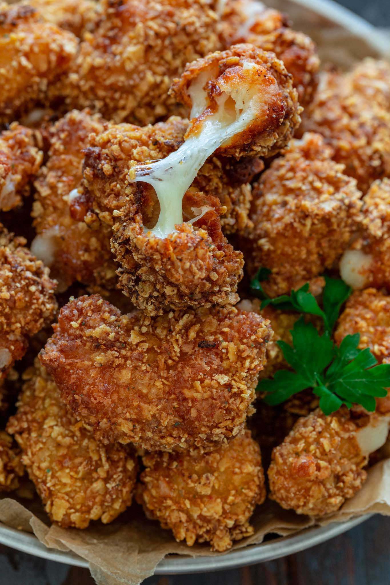 Cheese oozing out of a fried cheese curd