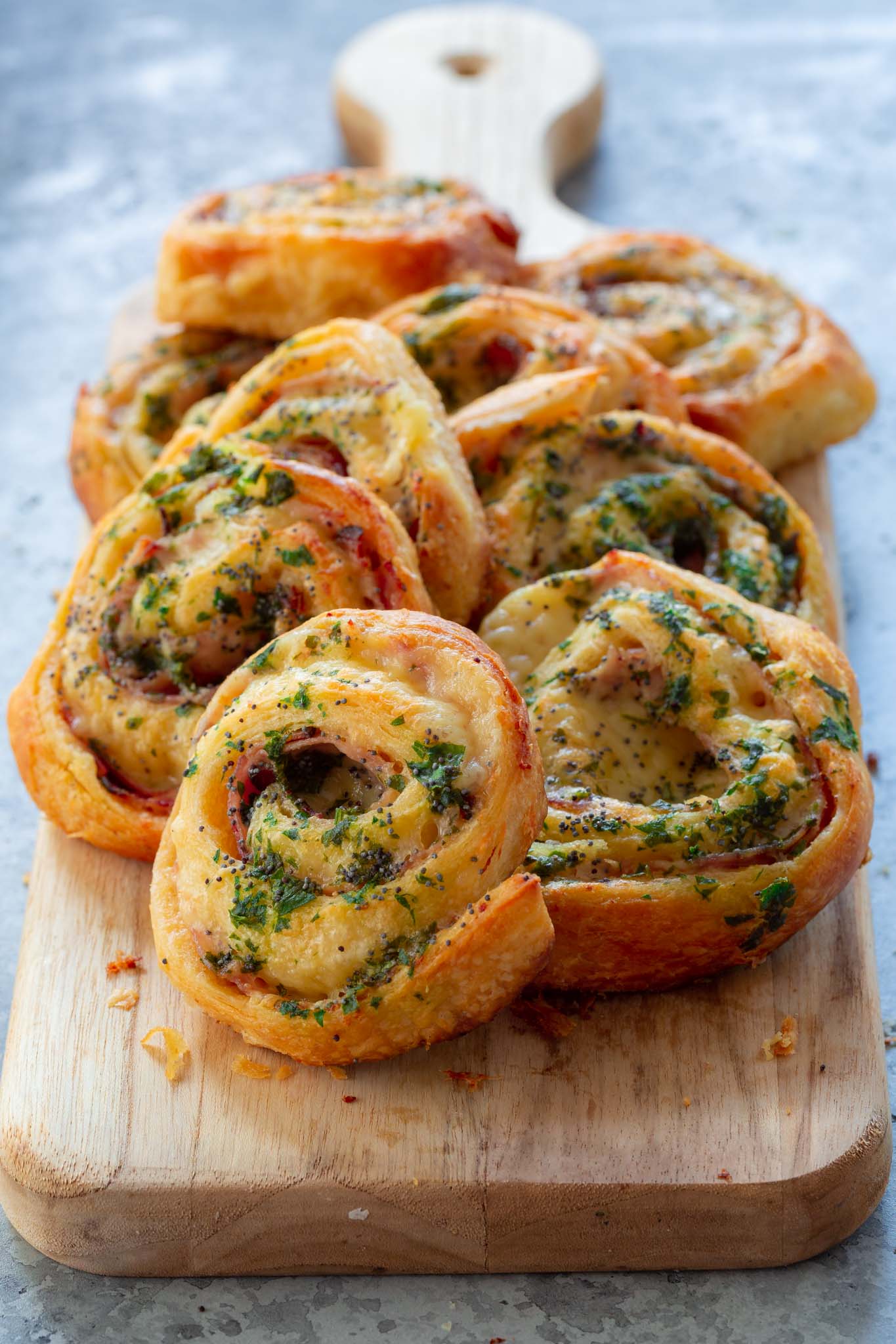 Ham and cheese pinwheels on a serving board.