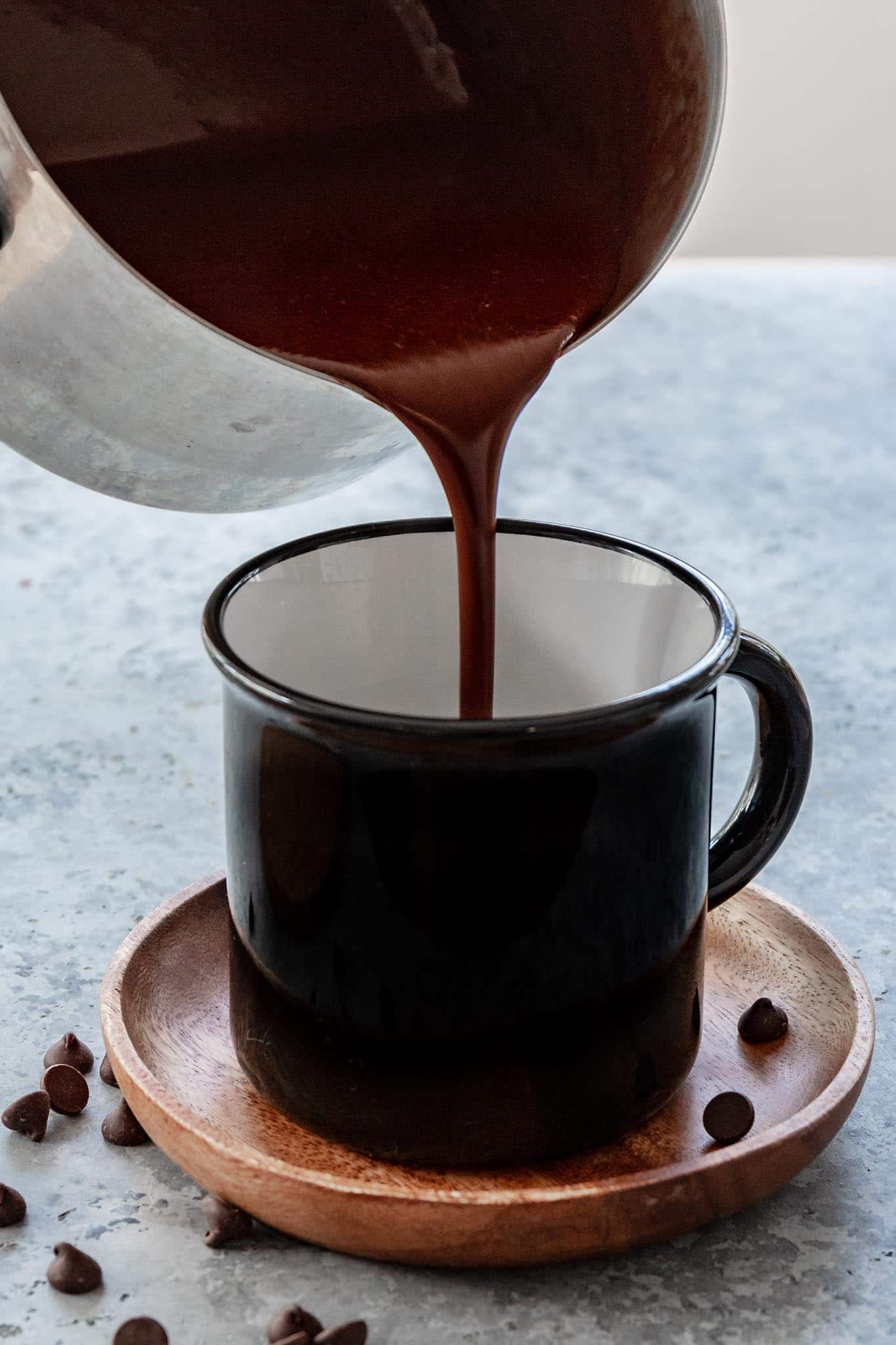 pouring hot chocolate in a mug