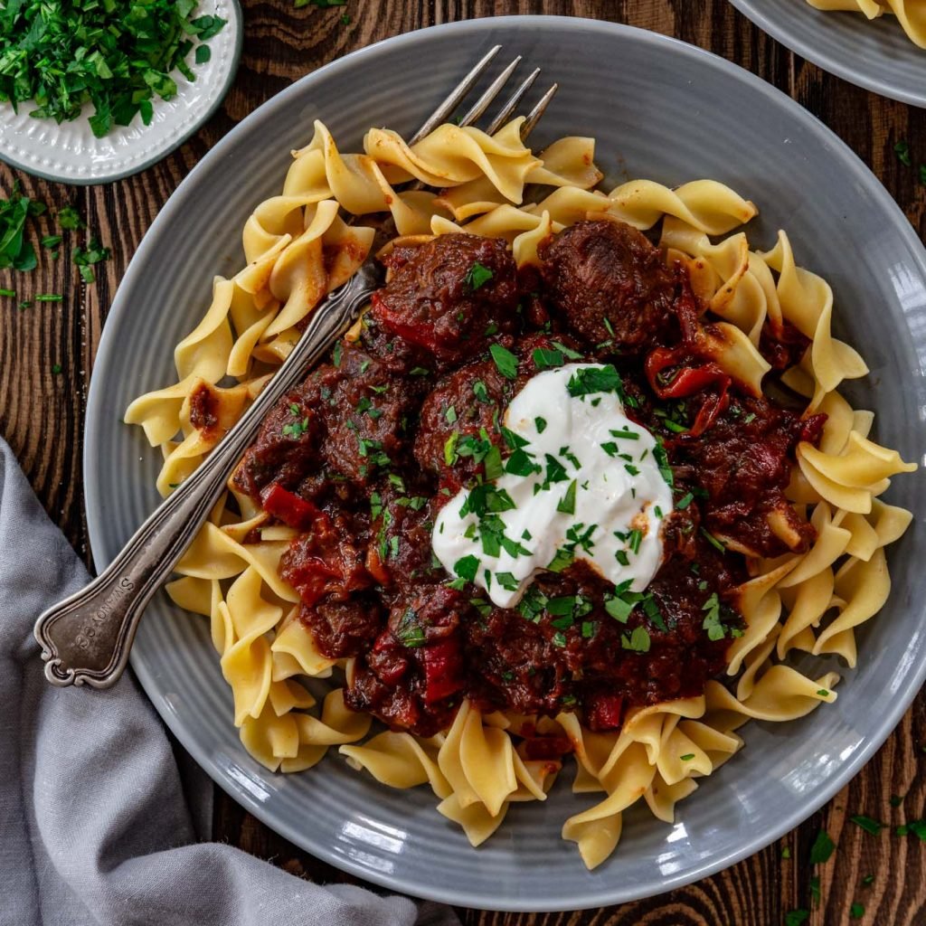 One serving of Porkolt over egg noodles