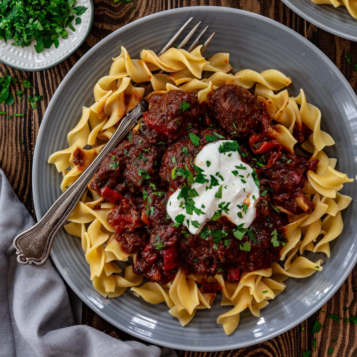 One serving of Porkolt over egg noodles