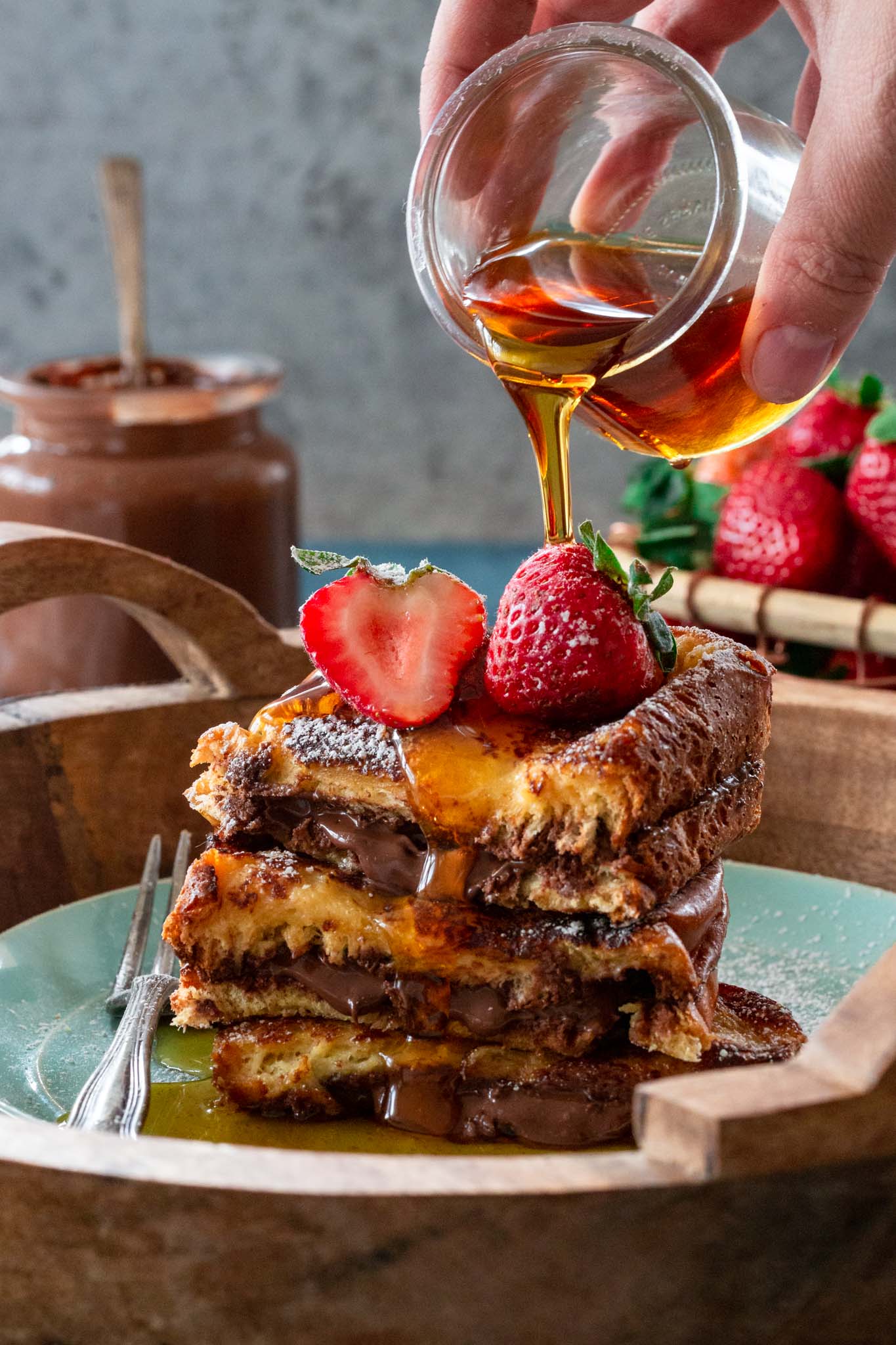 Pouring Maple syrup on Nutella French toast.