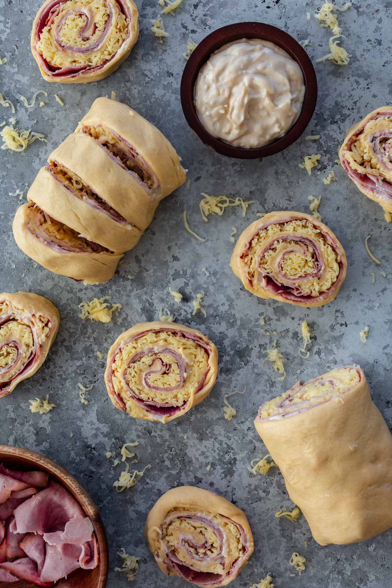 Cutting ham and cheese pinwheels.