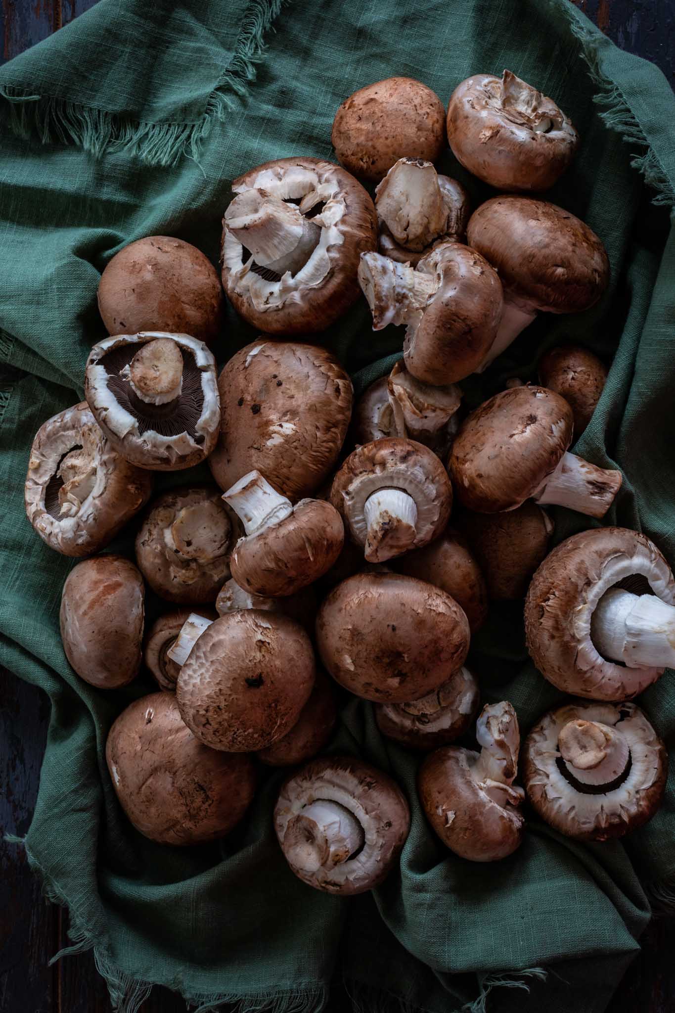 Cremini mushrooms on a towel.