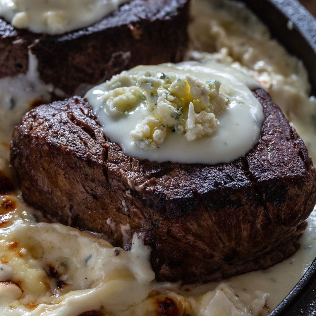 A juicy and thick tenderloin steak topped with blue cheese sauce