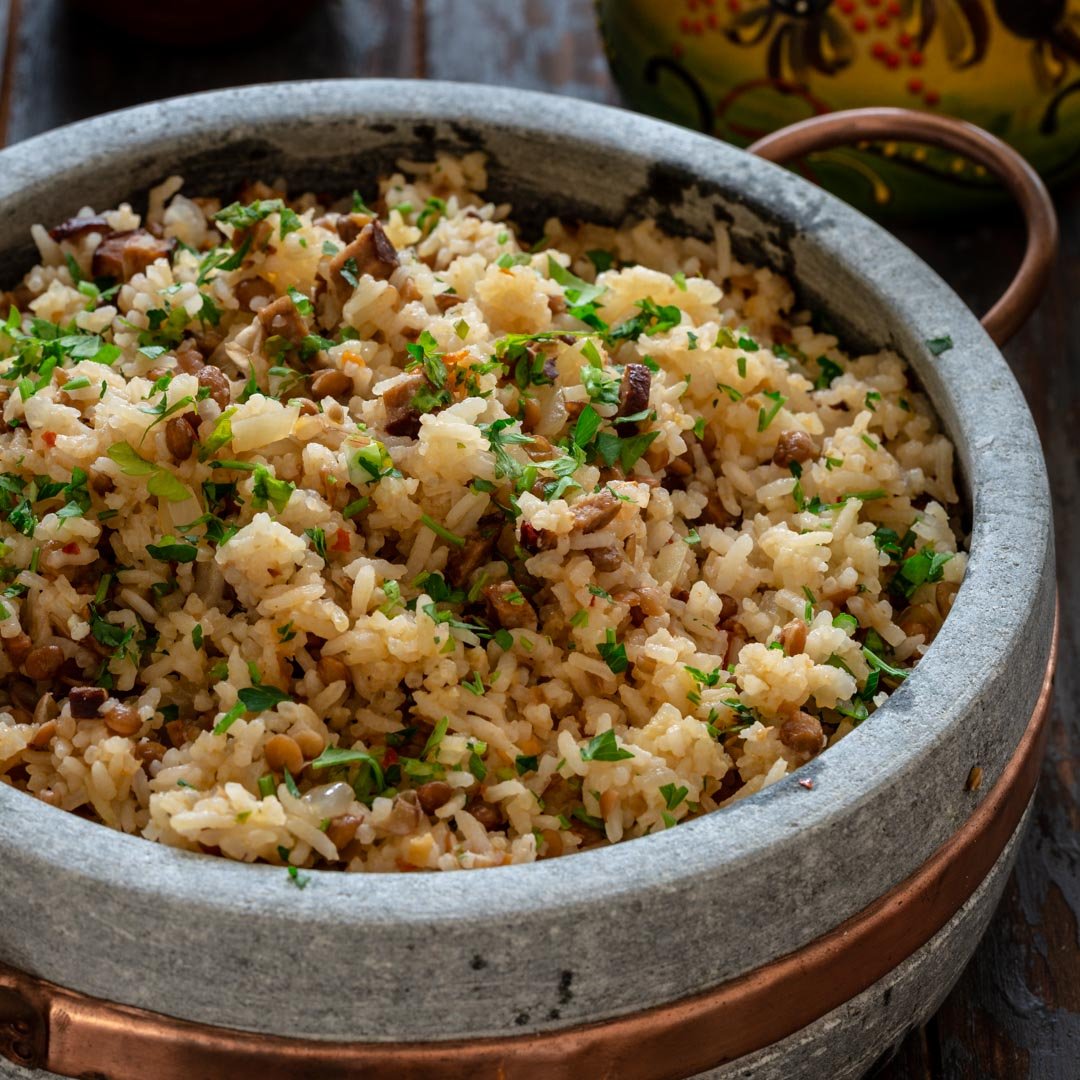 A pot of rice with sausage and lentils.