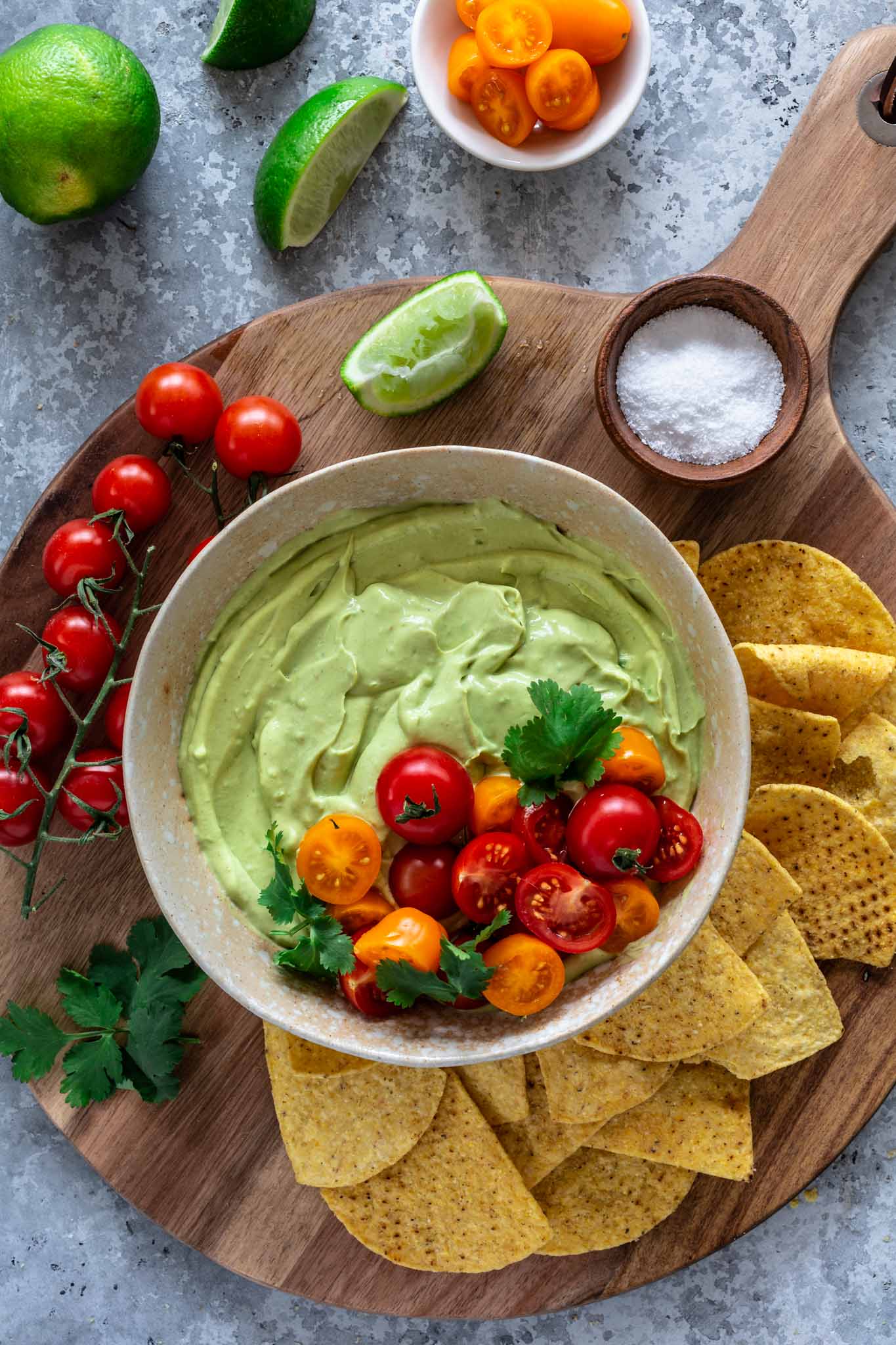 Whipped avocado dip topped with tomatoes and served with tortillas.