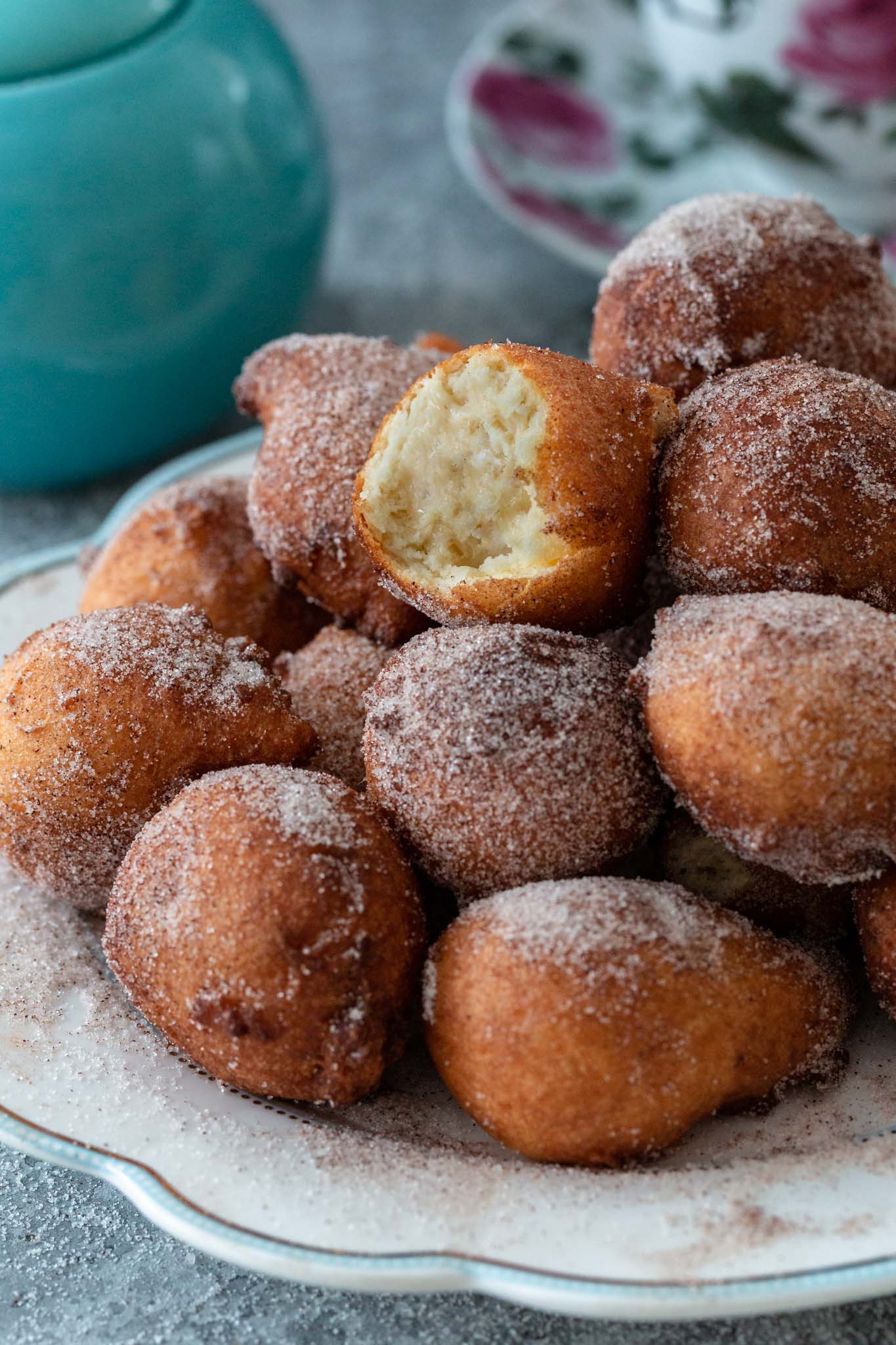 A pile of bolinhos de chuva and showing the inside of the top one.