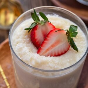 A close up shot of a glass of Brazilian coconut pudding.