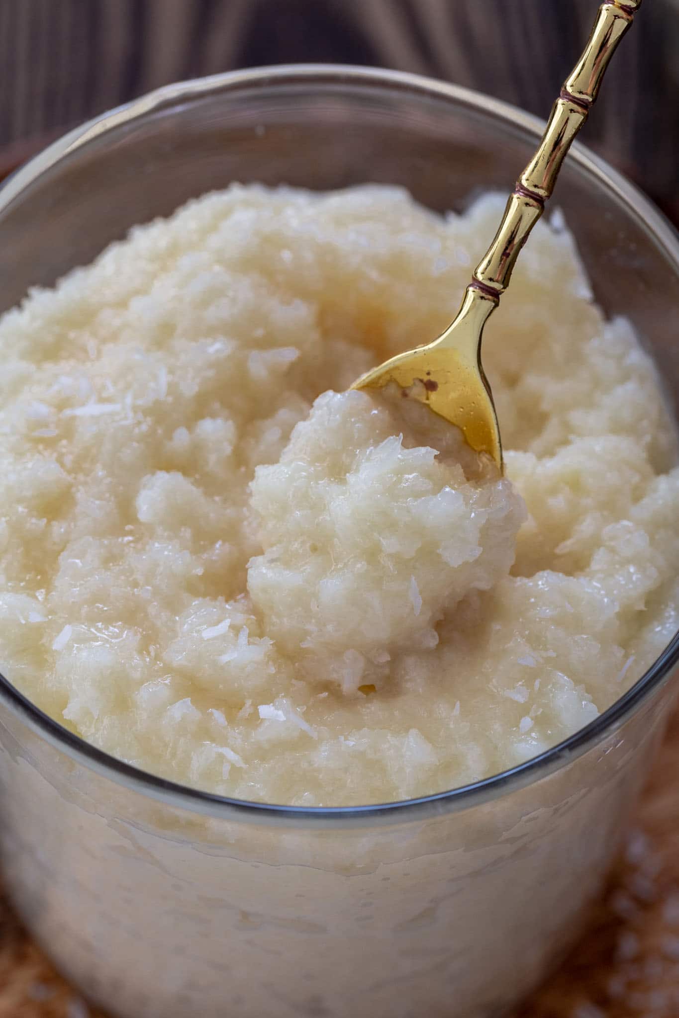 A close up of a spoonful of coconut pudding.