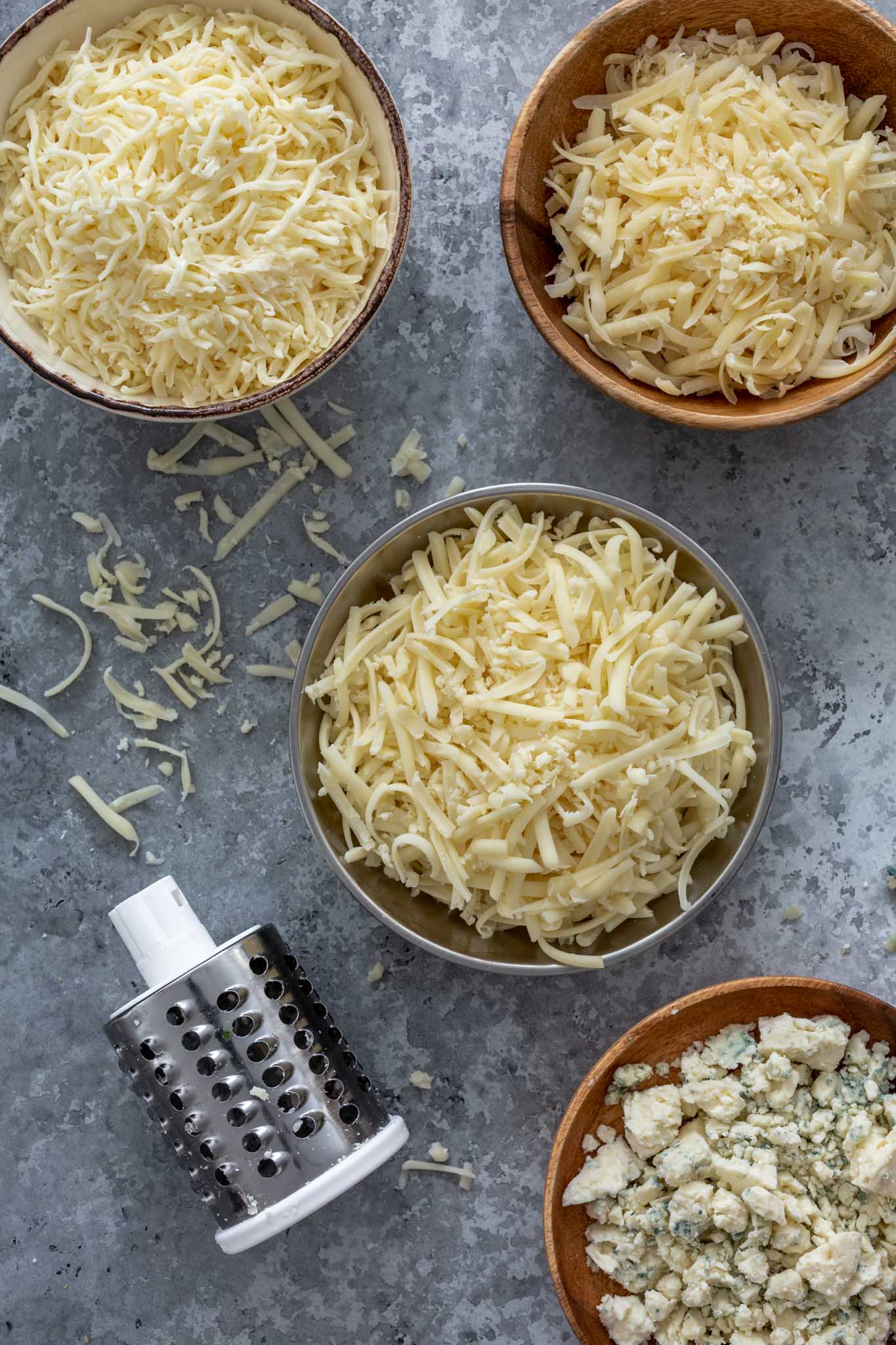 Four types of cheese: gorgonzola, gruyere, mozzarella and parmesan.