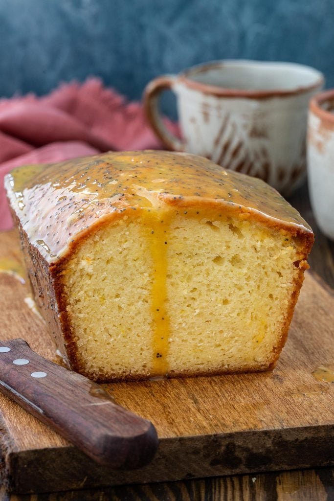 Fluffy and moist French Yogurt Cake topped with a tangy passion fruit yogurt glaze.