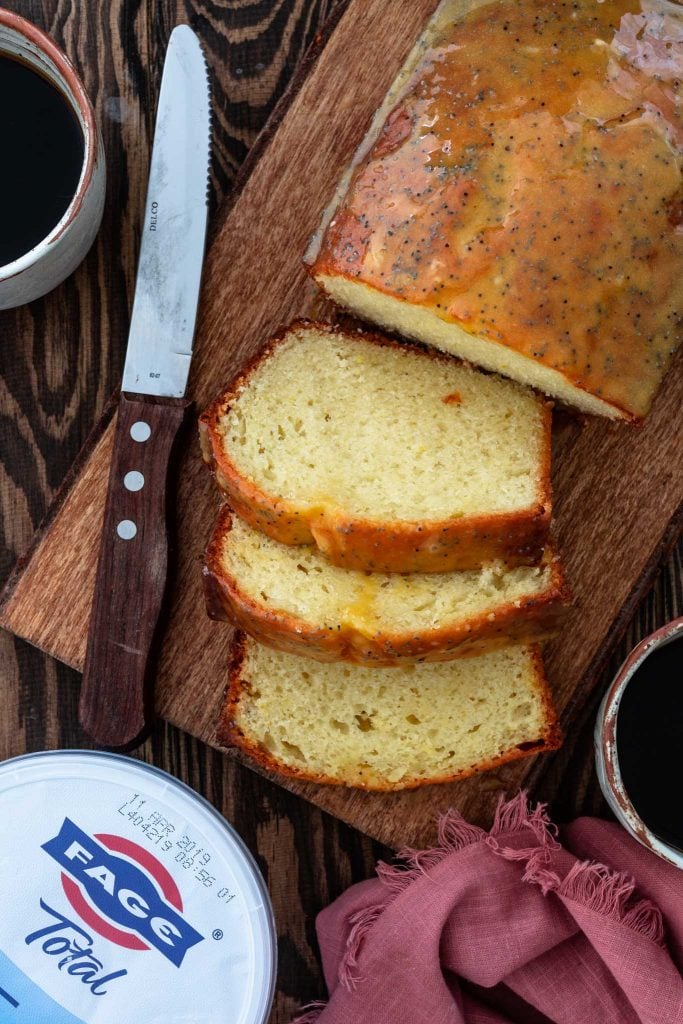 Sliced yogurt cake served with coffee.