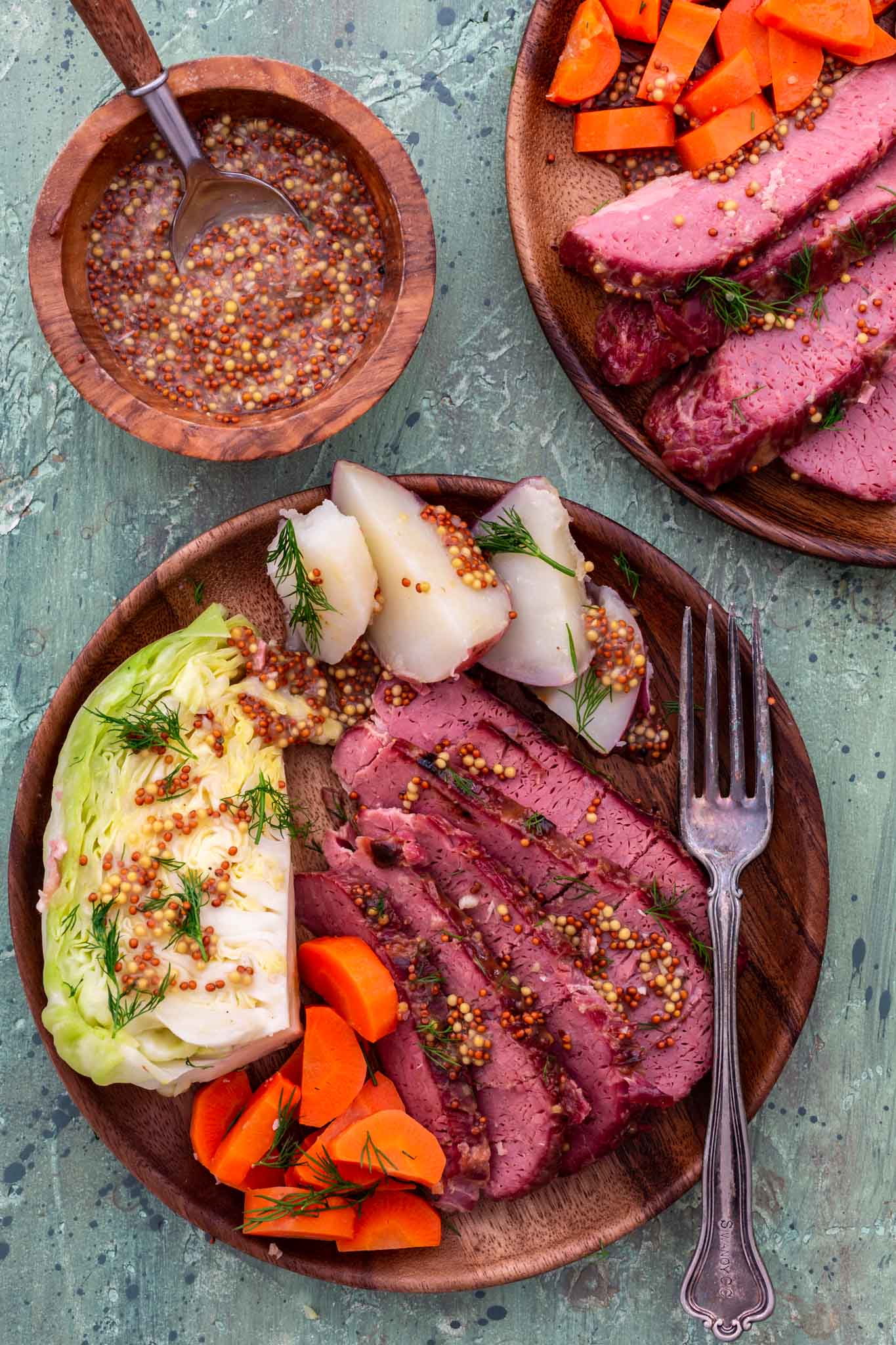 A plate of corned beef and cabbage with carrots and potatoes.