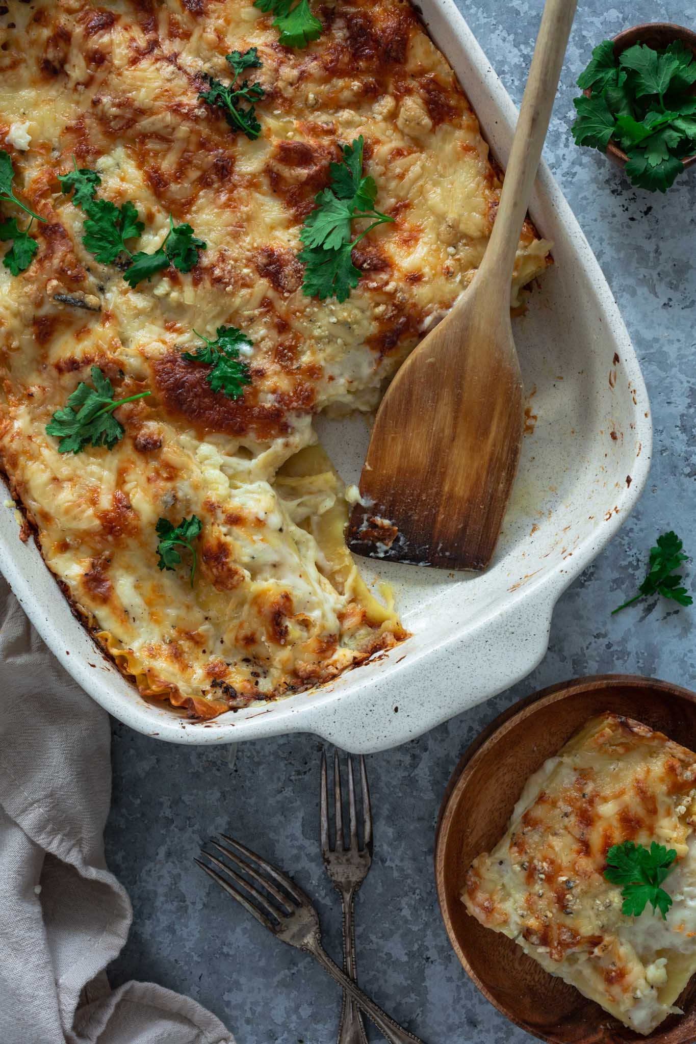 Four cheese lasagna being served from the pan.