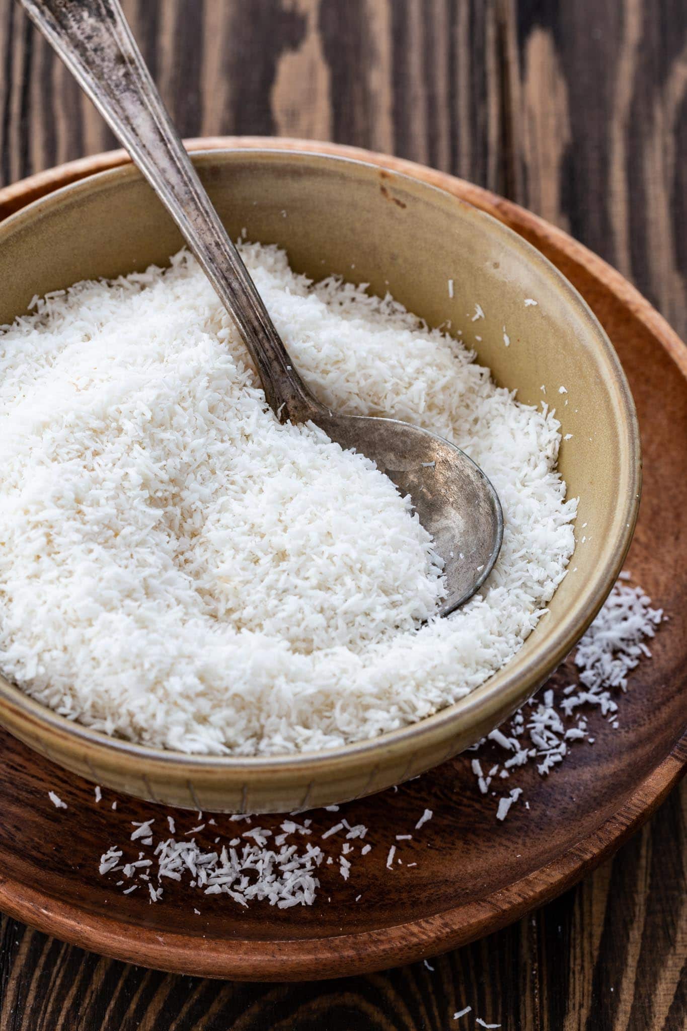 A small bowl of unsweetened shredded coconut.