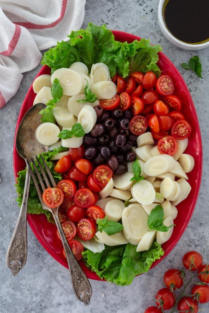 Hearts of Palm Salad with Cherry Tomatoes, small black olives, lettuce and basil.