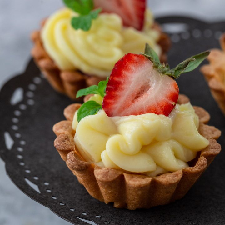 Brazilian strawberry tartlet on a stand.