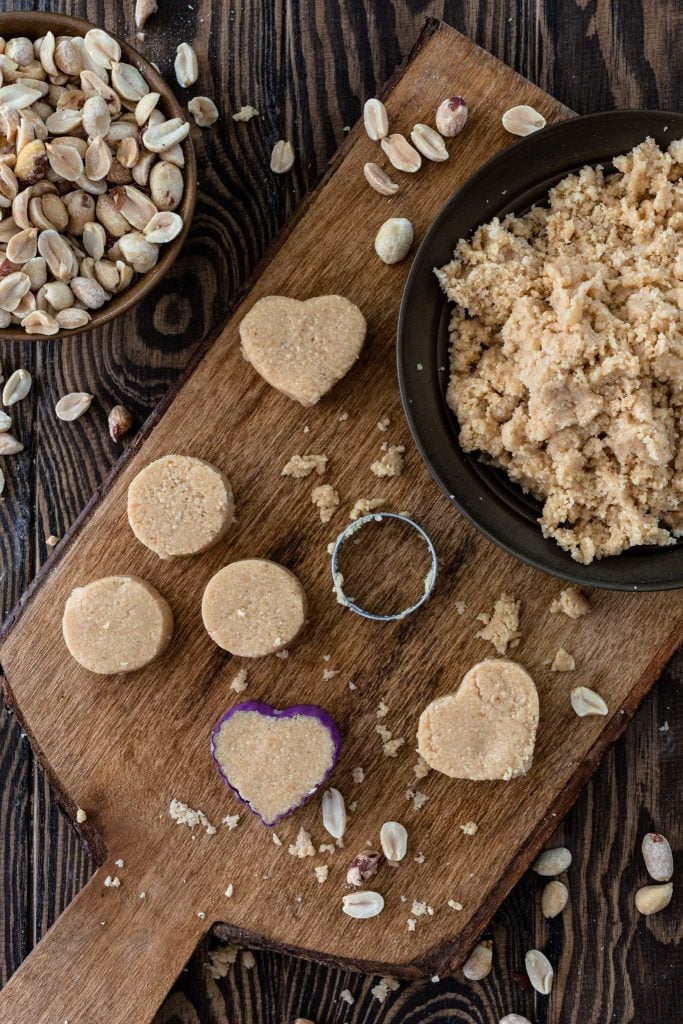 Using cookie cutters to mold peanut candies.