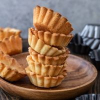 A pile of pâte sucrée tartlets.