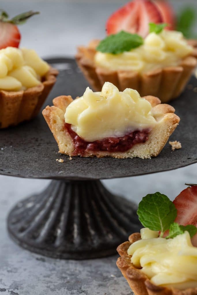 The inside of a Brazilian Strawberry Tartlet: a layer of strawberry jam and a layer of pastry cream.