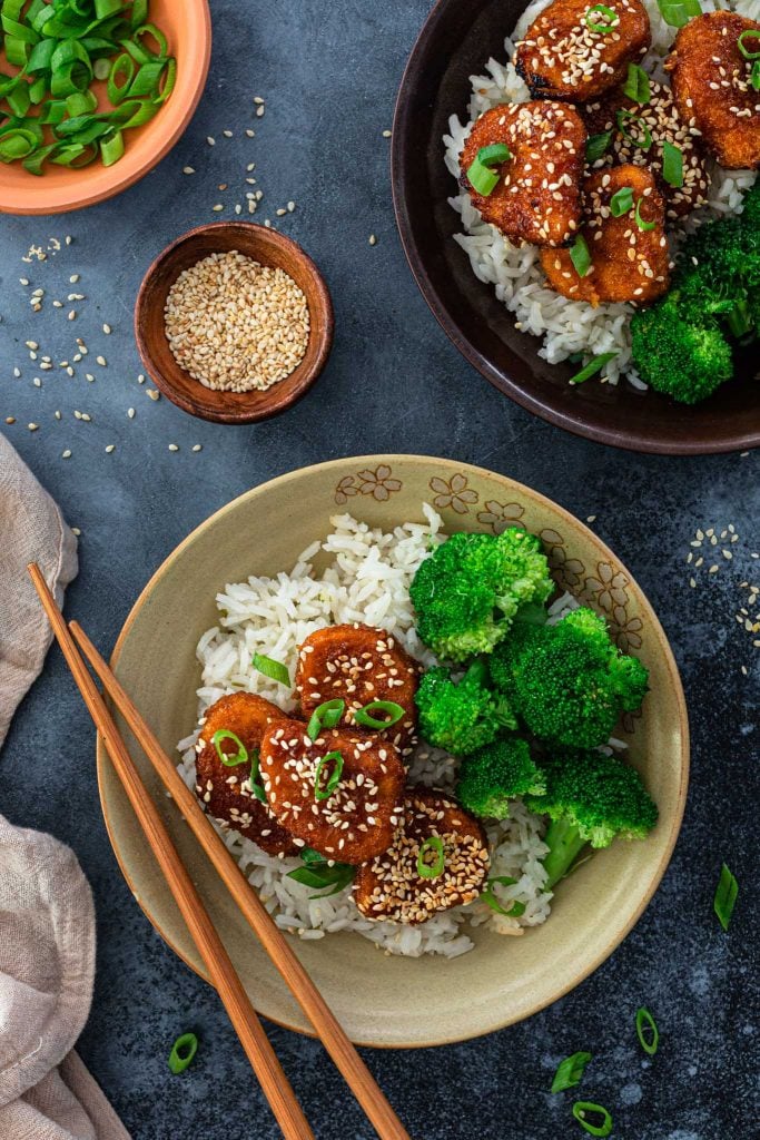 Honey glazed chicken nuggets served with rice and broccoli.