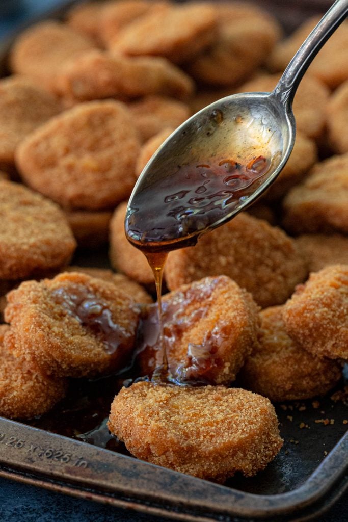 Pouring luscious honey garlic glaze on chicken nuggets