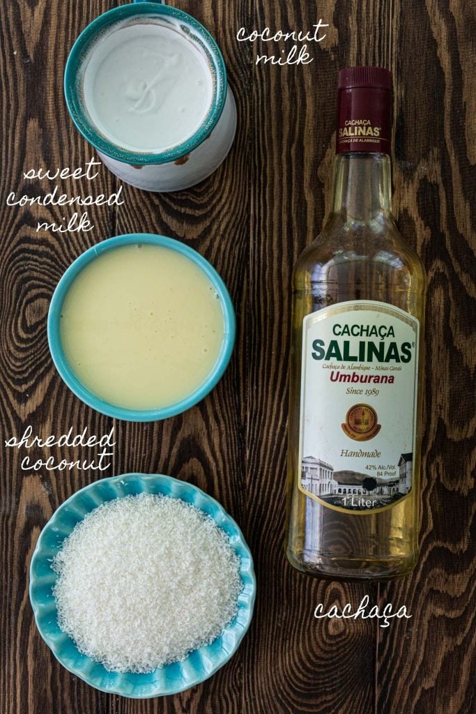 Ingredients to make Batida de Coco: coconut milk, sweet condensed milk, shredded coconut and cachaça.