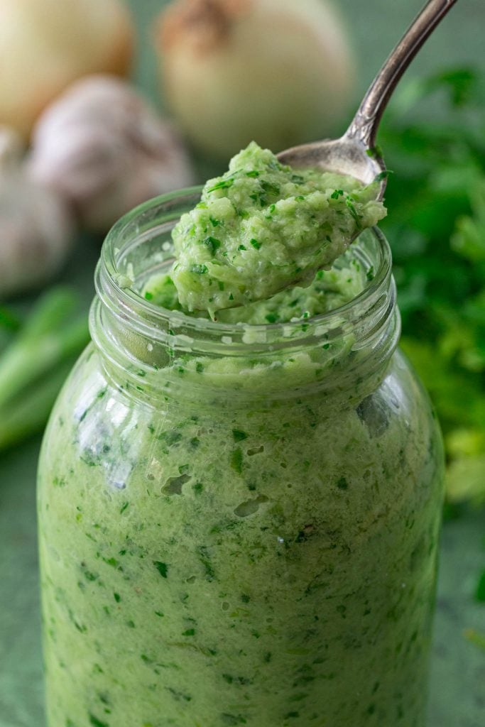 A spoonful of sofrito made with onions, garlic, herbs, salt, pepper and oil.