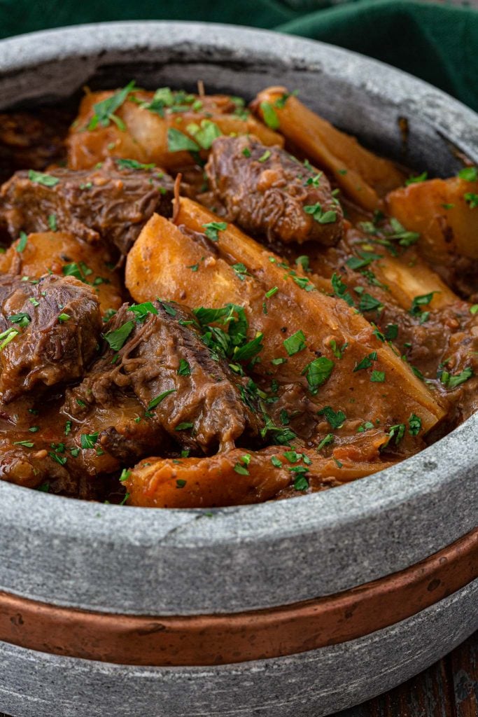 A pot of hearty beef stew made with short ribs and yucca.