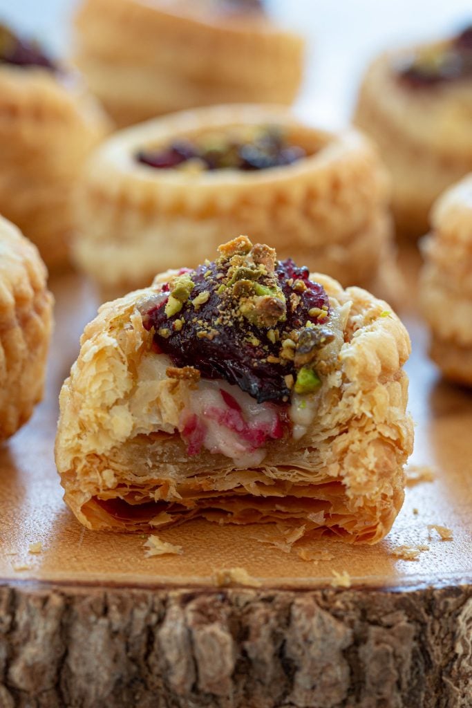 Vol au Vent stuffed with brie and topped with cranberry sauce and crushed pistachios.