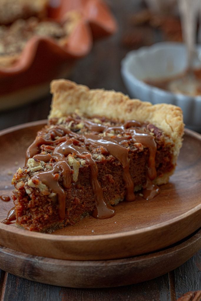 A slice of dulce de leche pecan pie drizzled with warm dulce de leche!