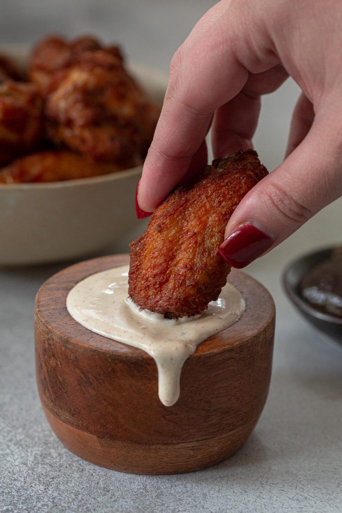 Dipping wings in sauce