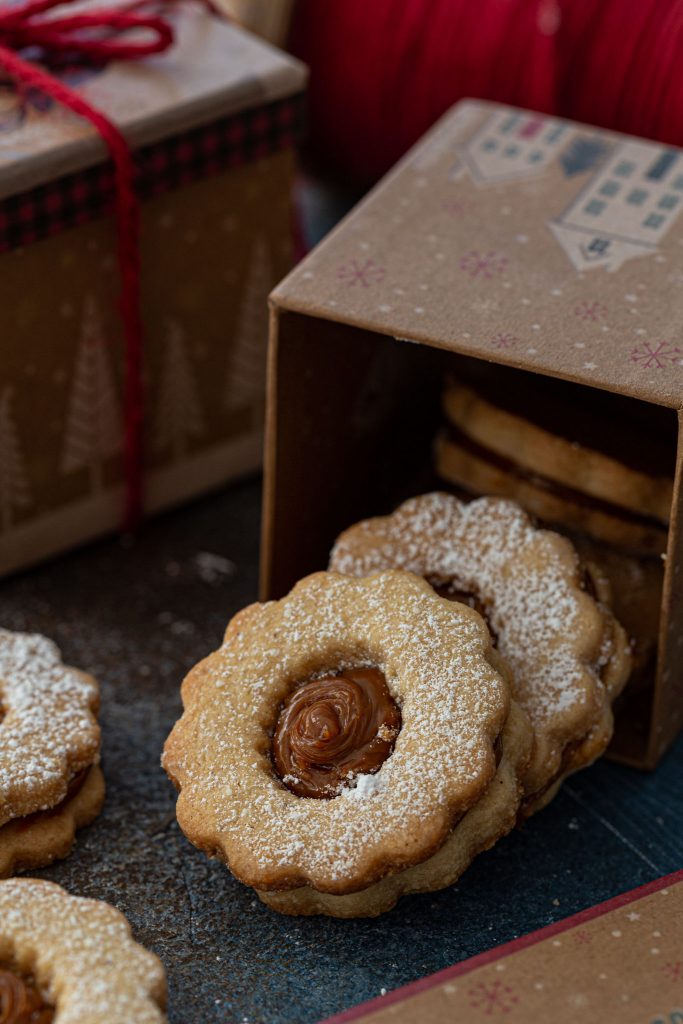 A box filled with dulce de leche linzer cookies.