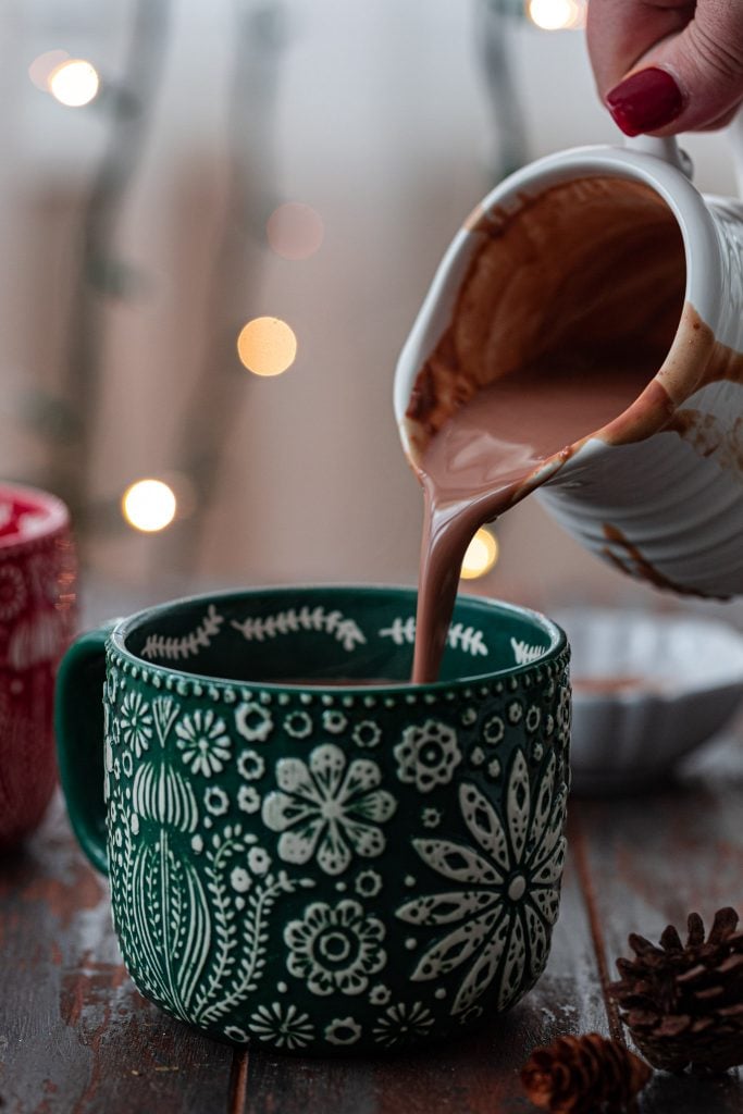 Pouring hot chocolate in a mug.