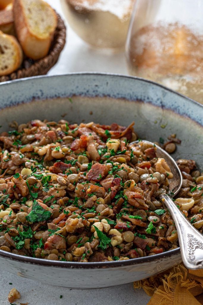 A salad made with green lentils, bacon, onions and nuts.