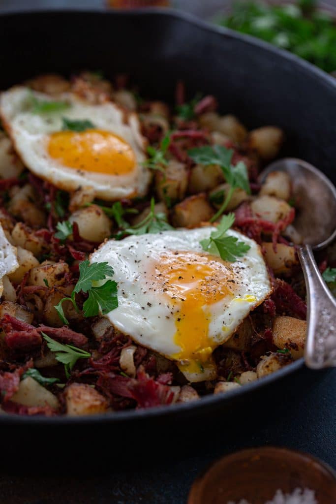 A runny yolk on corned beef hash.