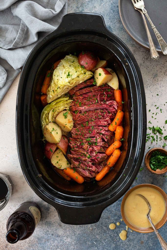 Corned beef cooked in the slow cooker with root vegetables and cabbage.