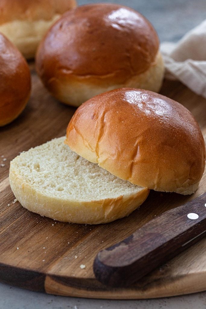 A brioche bun split in half.