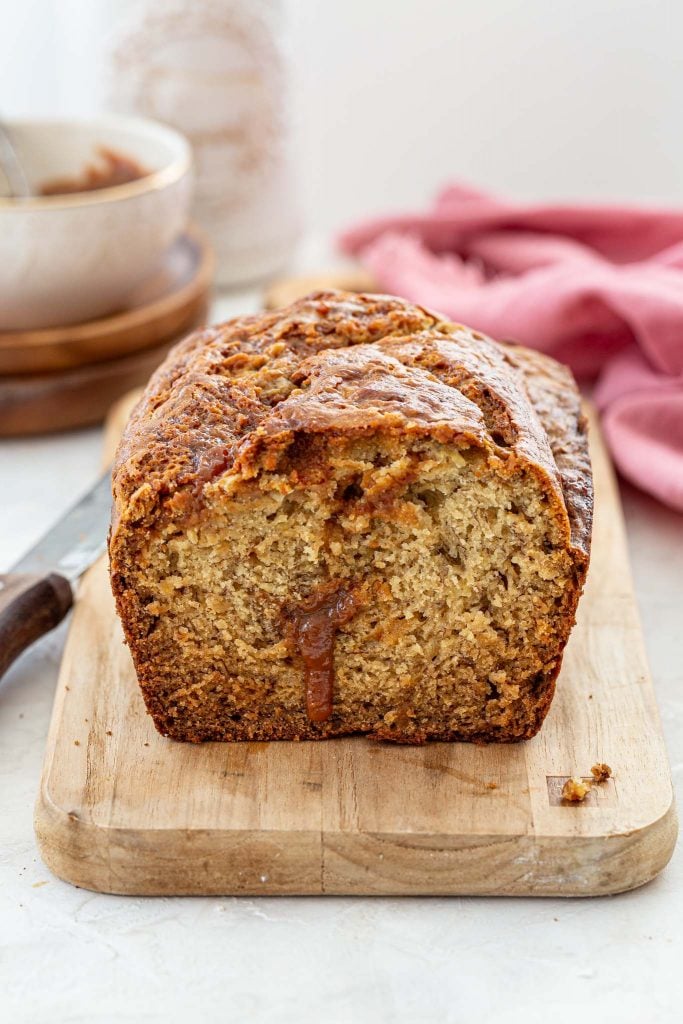 Dulce de leche oozing out of a loaf of banana bread.