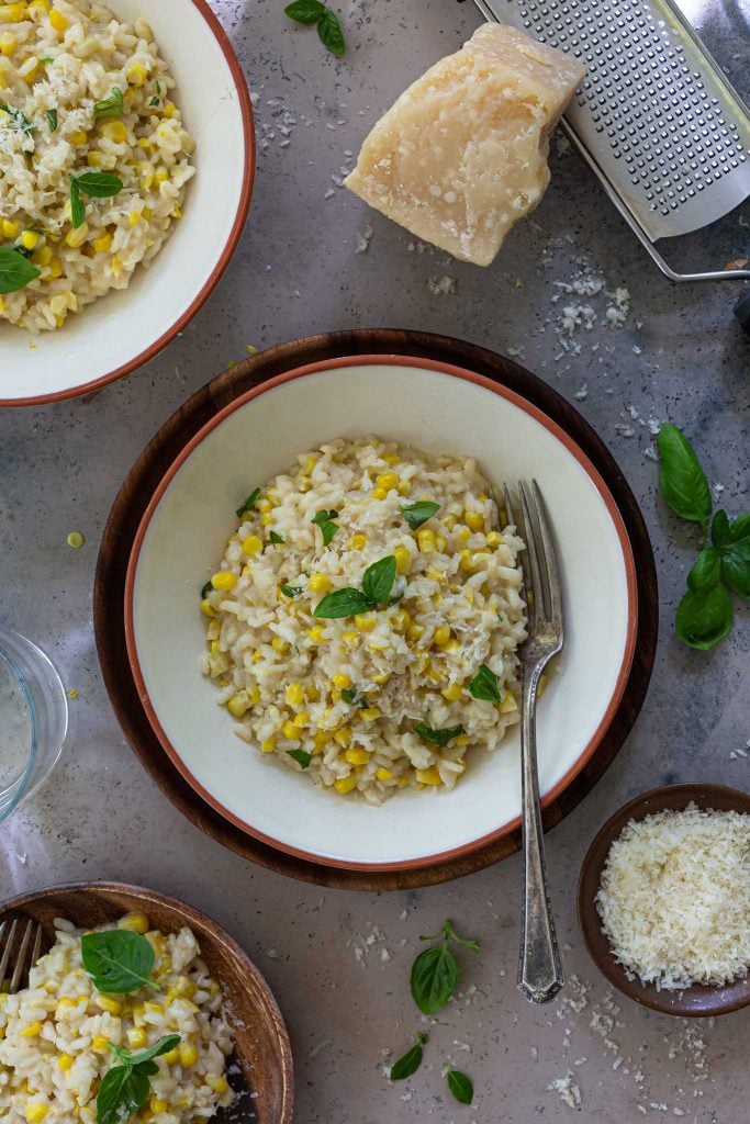 An overhead shot of fresh corn risotto in a bowl.