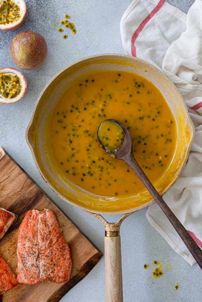 A skillet with passion fruit sauce.