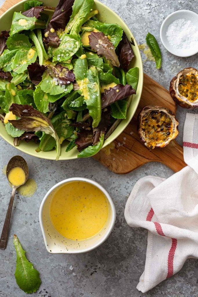 A green salad dressed with passion fruit dressing.