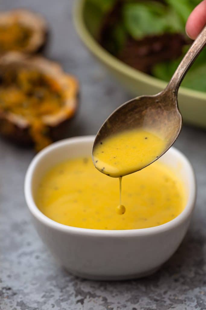 A close up shot of passion fruit salad dressing.