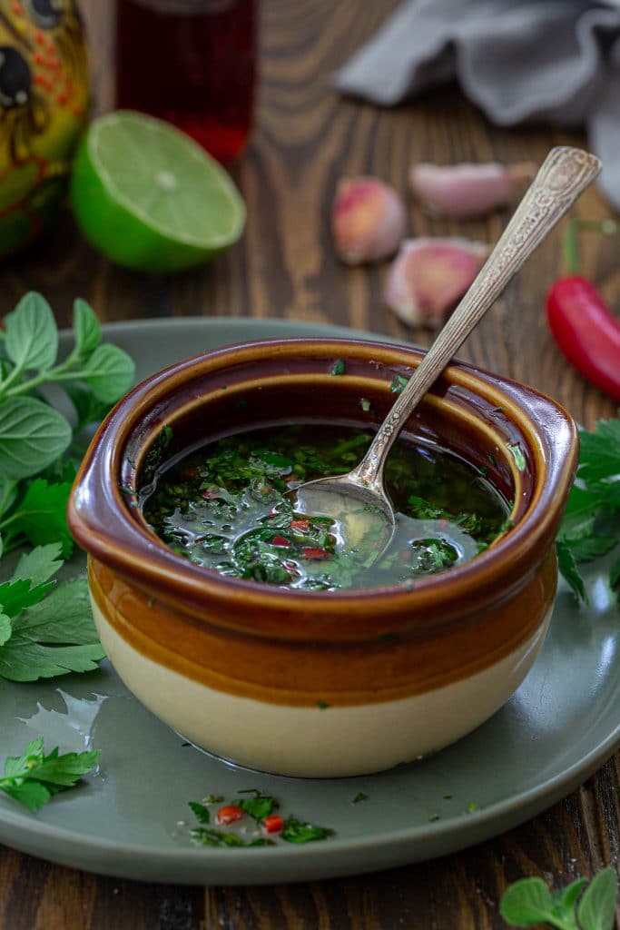 A 45 degree angle shot of Argentinian chimichurri sauce.