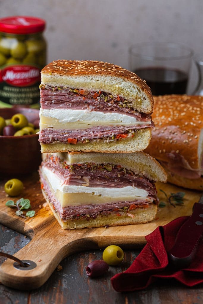 Two Muffuletta wedges, stacked.