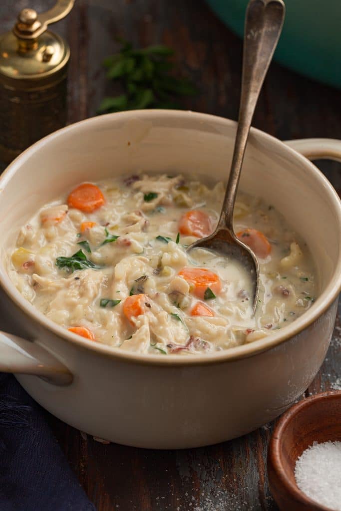 A bowl of creamy chicken and rice soup.