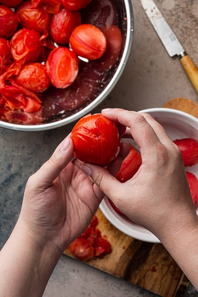 A close up photo of how to peel tomatoes.