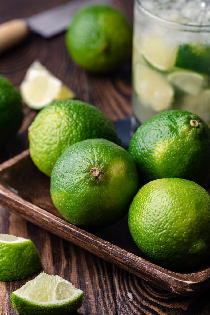 Four limes in a tray.