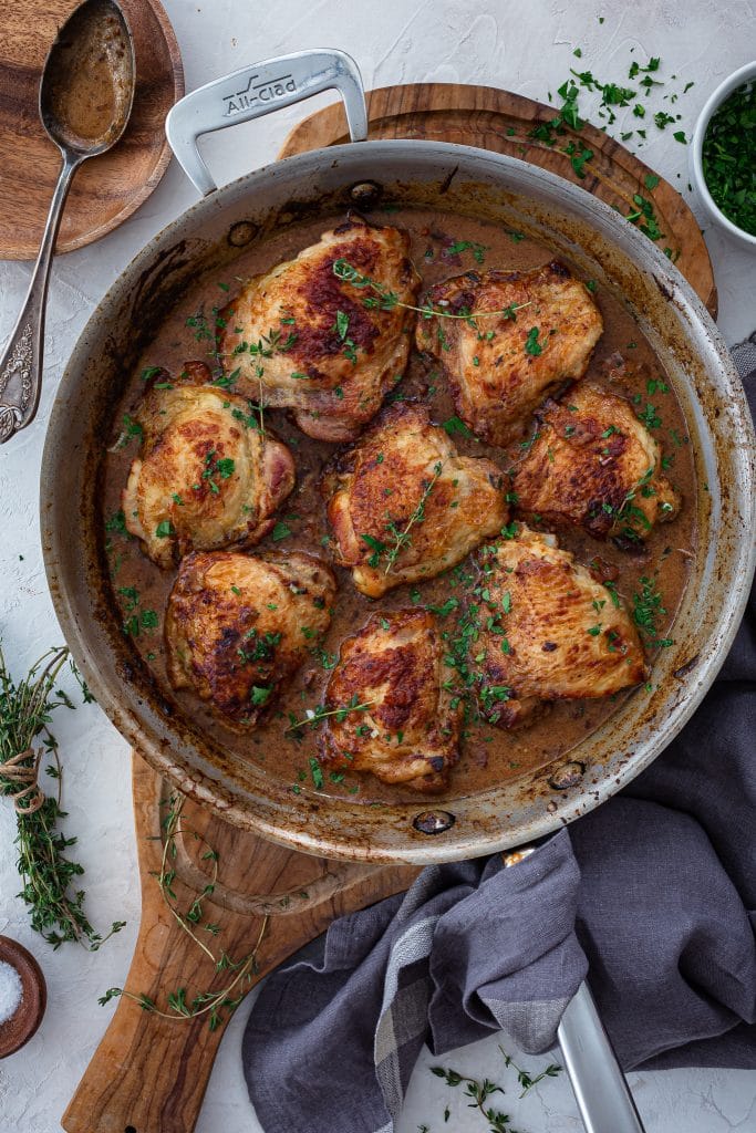 An overhead photo of a skillet full of French mustard chicken.